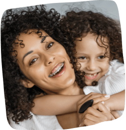 mother and daughter smiling with braces